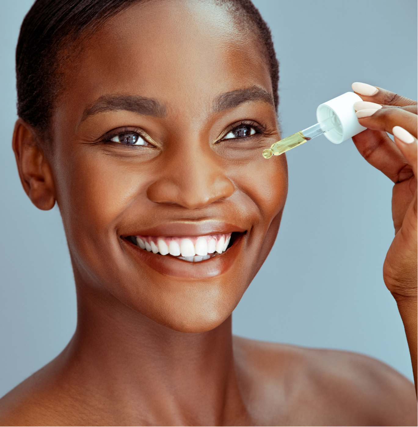 Radiance Renewal Facial Oil being applied by a smiling woman with glowing skin, showcasing its nourishing properties.